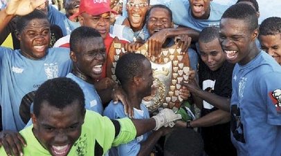 St George's College players celebrating after they lifted the Olivier Shield, symbol of all-island supremacy in schoolboy football, last season. - File