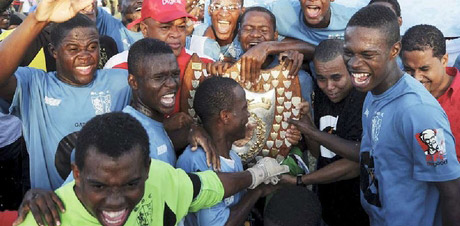 St George's College players celebrating after they lifted the Olivier Shield, symbol of all-island supremacy in schoolboy football, last season. - File