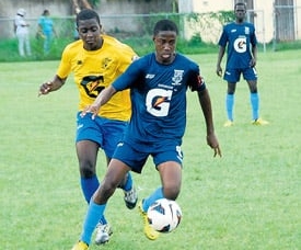 Andre Smith of Mannings (right) tries to get away from Cedric Titus’ Romario Blake during their ISSA/Gatorade/Digicel daCosta Cup quarter-final match at Drax Hall on Saturday. Cedric Titus won 2-1. (Photo: Paul Reid)