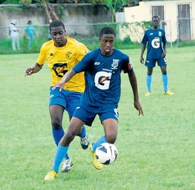 Andre Smith of Mannings (right) tries to get away from Cedric Titus’ Romario Blake during their ISSA/Gatorade/Digicel daCosta Cup quarter-final match at Drax Hall on Saturday. Cedric Titus won 2-1. (Photo: Paul Reid)