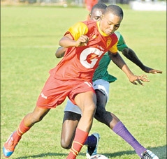 Cornwall College’s Ackeem McCarthy (foreground) gets away from William Knibb Memorial’s Brad Johnson in their ISSA/Gatorade/Digicel daCosta Cup Inter-zone game at Jarrett Park yesterday. Cornwall College won the game 4-0. (Photo: Paul Reid)
