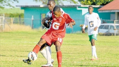 Newton Henry of Glenmuir High (foreground) tries to control the ball as he comes under pressure from Frome Technical's Clive Wiliams in yesterday's ISSA/Gatorade/Digicel daCosta Cup quarter-final game at the Frome Sports Club. The game ended in a 0-0. (Photo: Paul Reid)