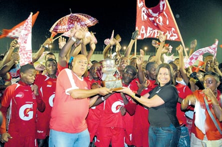 Glenmuir’s captain Kamal Henry (centre) accepts the ISSA/Gatorade/Digicel daCosta Cup from Digicel’s Mark Martin (left) and Gatorade’s Daniel Barnes after beating St Elizabeth Technical 1-0 in the final at Montego Bay Sports Complex yesterday. (Photo: Paul Reid)