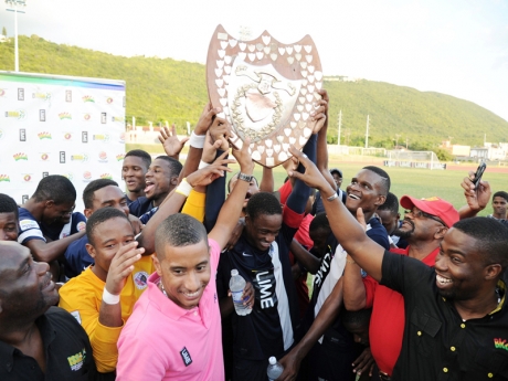 An elated Jamaica College team, supporters and sponsors lift the 2013 Olivier Shield. - Ricardo Makyn photo