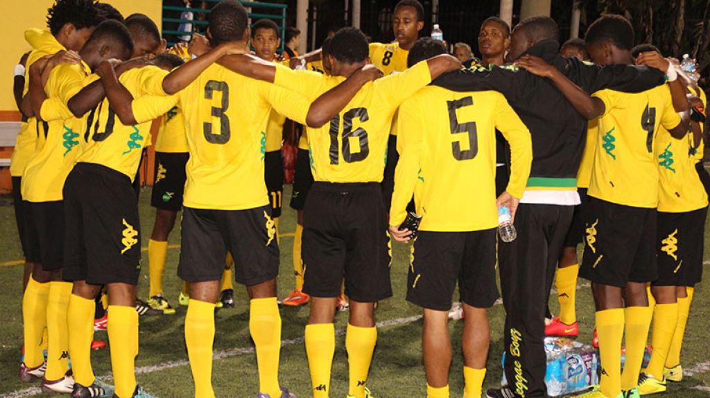 ETERNAL FATHER, BLESS US. Members of the Jamaica National U-17 team embrace each other prior to the start of their match with Plantation U-19, at the Lauderhill Stadium, Fort Lauderdale, Saturday. Jamaica won 4-1 and will play in the final on Sunday. Paul Perry Photo