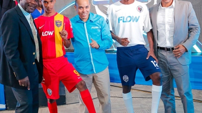 L-R - Dr. Walton Small , President of ISSA, David Shirley (centre) of Locker Room Sports Ltd and Carlo Redwood ( right), VP Marketing & Products at Flow Jamaica pose with students wearing the new ISSA/FLOW Super Cup kit sponsored by international sports apparel manufacturer, Nike. All player in the 2015 competition will receive full jersey kit including footwear.