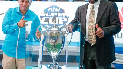 Carlo Redwood (left), Vice President - Marketing & Products at FLOW Jamaica and Dr. Walton Small, President of the Inter-Secondary School Sports Association ( ISSA) pose with the newly unveiled FLOW Super Cup trophy during the launch of the ISSA/FLOW Super Cup Competition held at the Montego Bay Convention Centre on Tuesday, October 6, 2015.