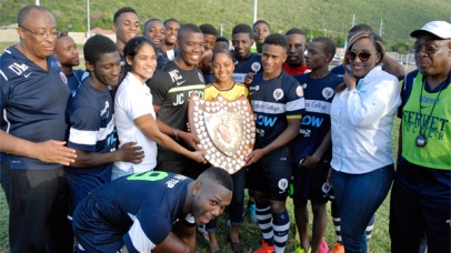Members of the Jamaica College team pose with the Olivier Shield after defeating STETHS 2-1 at the Stadium East Field on Saturday.